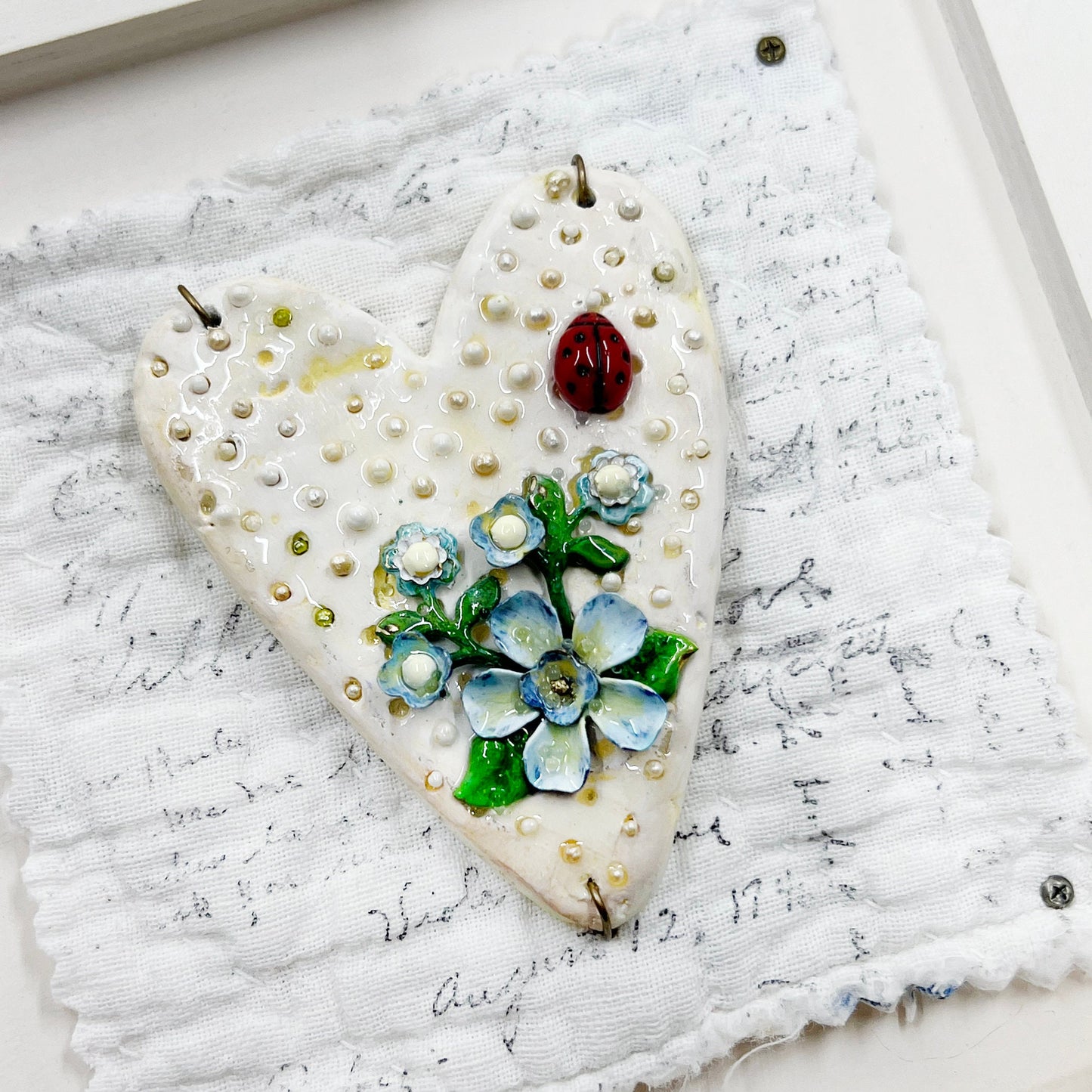 Handmade Heartfelt Sampler 1: framed hand sculpted heart with hand-painted enameled flowers by artist Tammy Tutterow